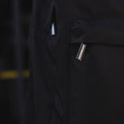 Hoonigan CENSOR BAR Light Backpack featuring a sleek design with a prominent logo, adjustable straps, and multiple compartments for storage.