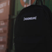 Hoonigan CENSOR BAR Light Backpack featuring a sleek black design with a prominent logo, adjustable straps, and multiple compartments for functionality.