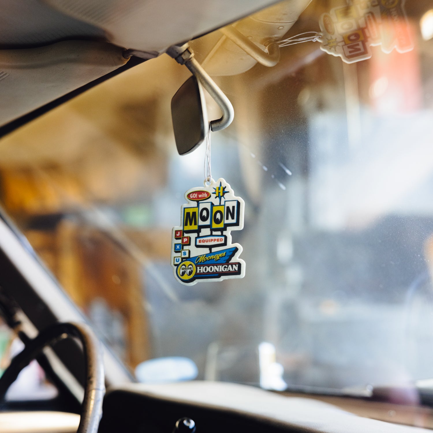 Hoonigan x Mooneyes MOON MOTEL Air Freshener featuring a retro motel design and vibrant colors.