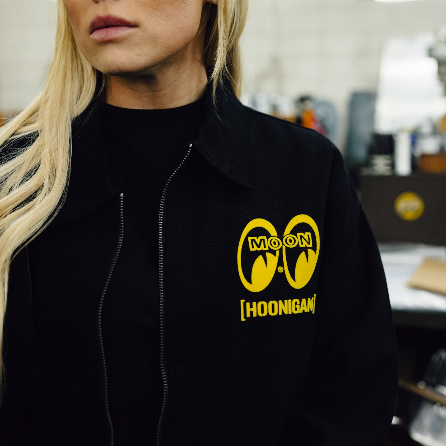 Hoonigan x Mooneyes SO CAL Jacket featuring black and yellow design, front zip closure, and embroidered logos.