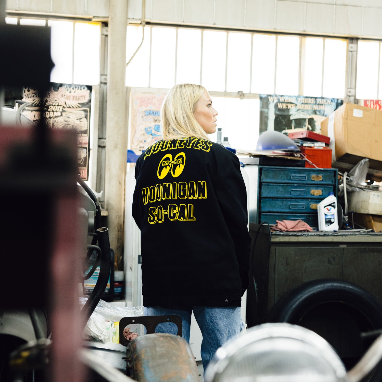 Hoonigan x Mooneyes SO CAL Jacket featuring a black design with vibrant yellow accents and logos on the front and back.