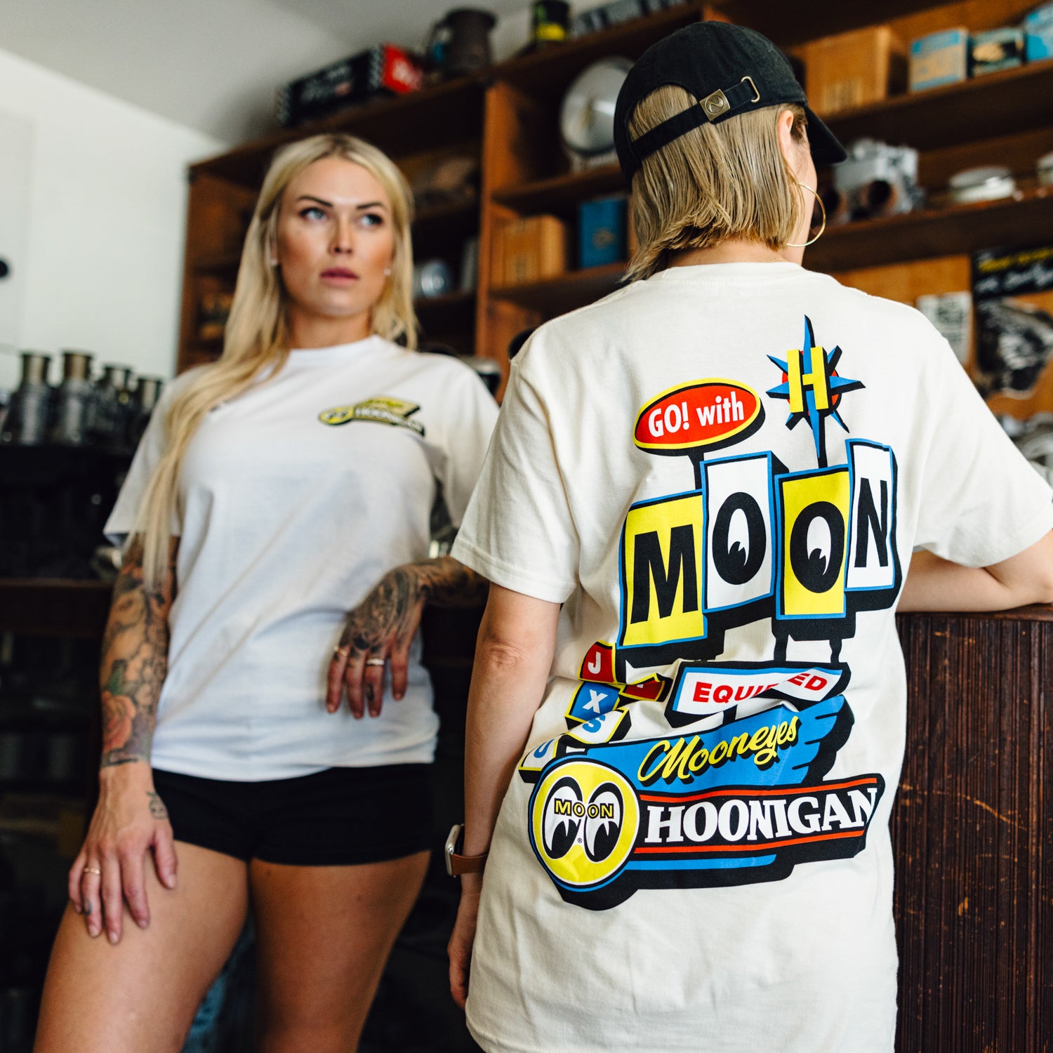 Hoonigan x Mooneyes MOONMOTEL short sleeve tee featuring a vintage-style graphic design on a black background.