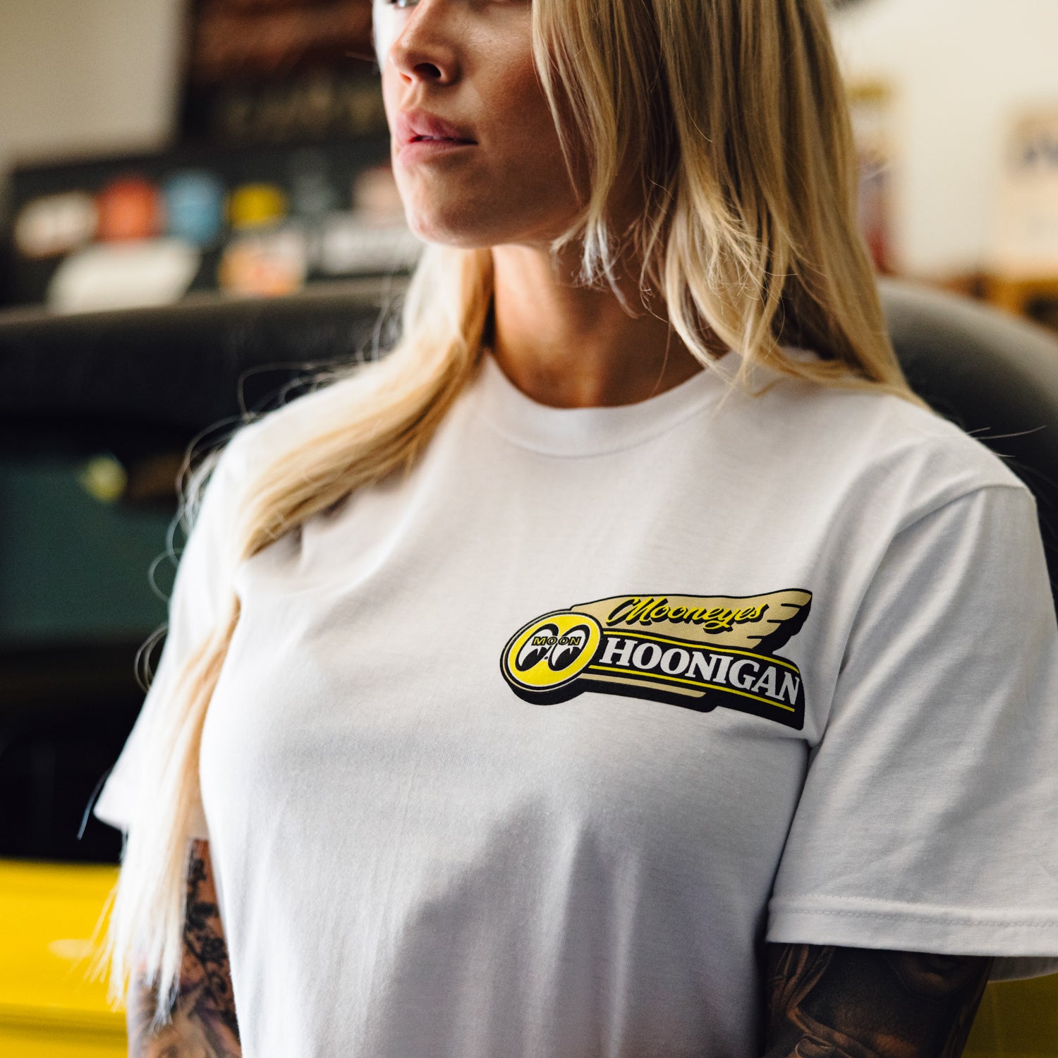 Hoonigan x Mooneyes MOONMOTEL Short Sleeve Tee featuring a retro motel graphic and logo on a black background.