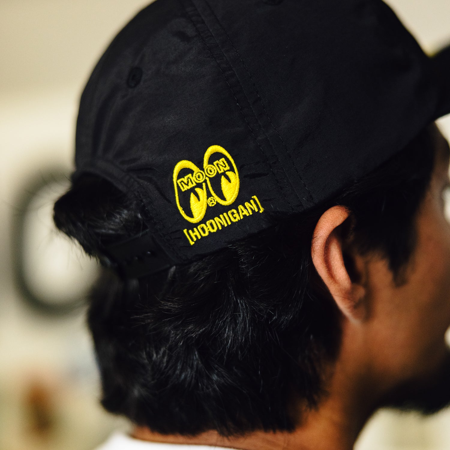 Hoonigan x Mooneyes decorated unstructured snapback hat with black base and colorful embroidered logo.