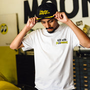 Hoonigan x Mooneyes decorated unstructured snapback hat featuring a black base with embroidered logo designs in yellow and white.