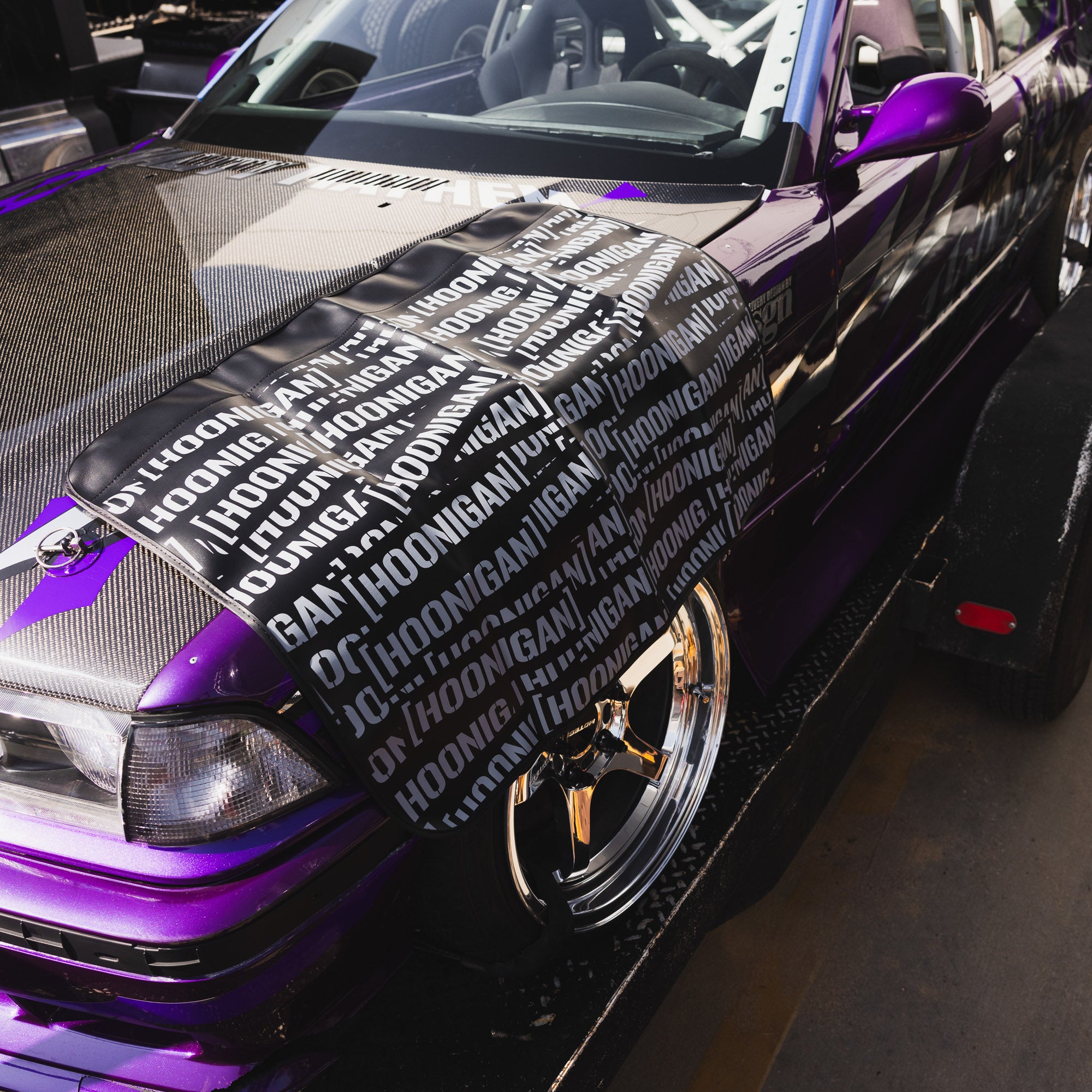 Hoonigan SCATTER PRINT Fender Cover featuring a vibrant, multicolored design with the Hoonigan logo.