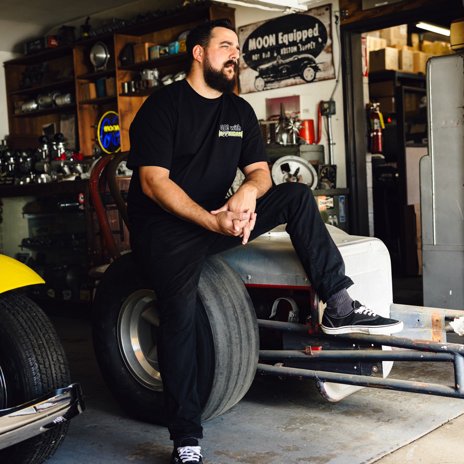 Hoonigan x Mooneyes short sleeve t-shirt featuring a graphic design with "HOON AND MOON" text, in black and yellow color scheme.