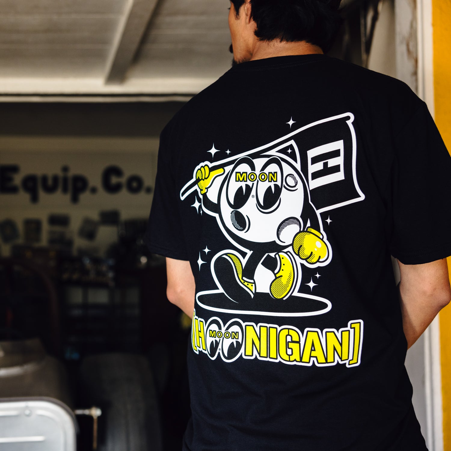 Hoonigan x Mooneyes MASCOT Short Sleeve Tee featuring a bold graphic print on the front, in black fabric, suitable for car enthusiasts.