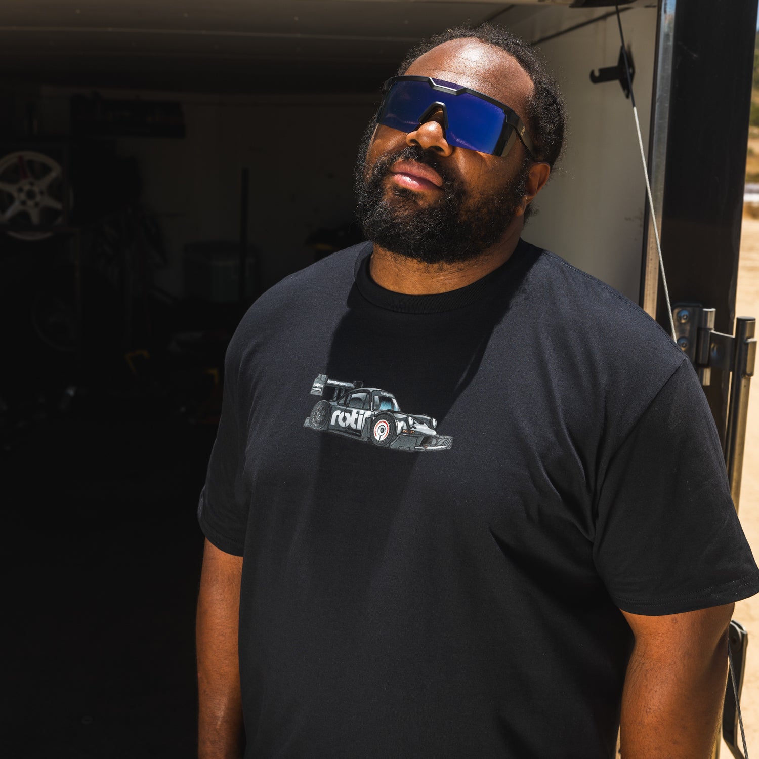 Rotiform SD SERIES Short Sleeve Tee featuring a bold graphic design on a black fabric background.