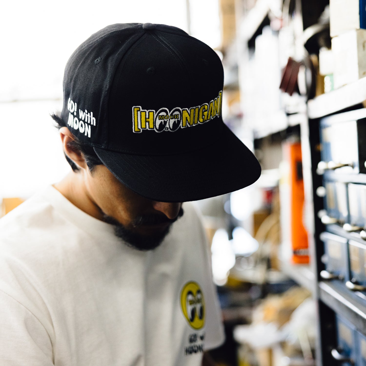 Hoonigan x Mooneyes MOON BAR Snapback Hat featuring a black cap with white logo embroidery and a flat brim.
