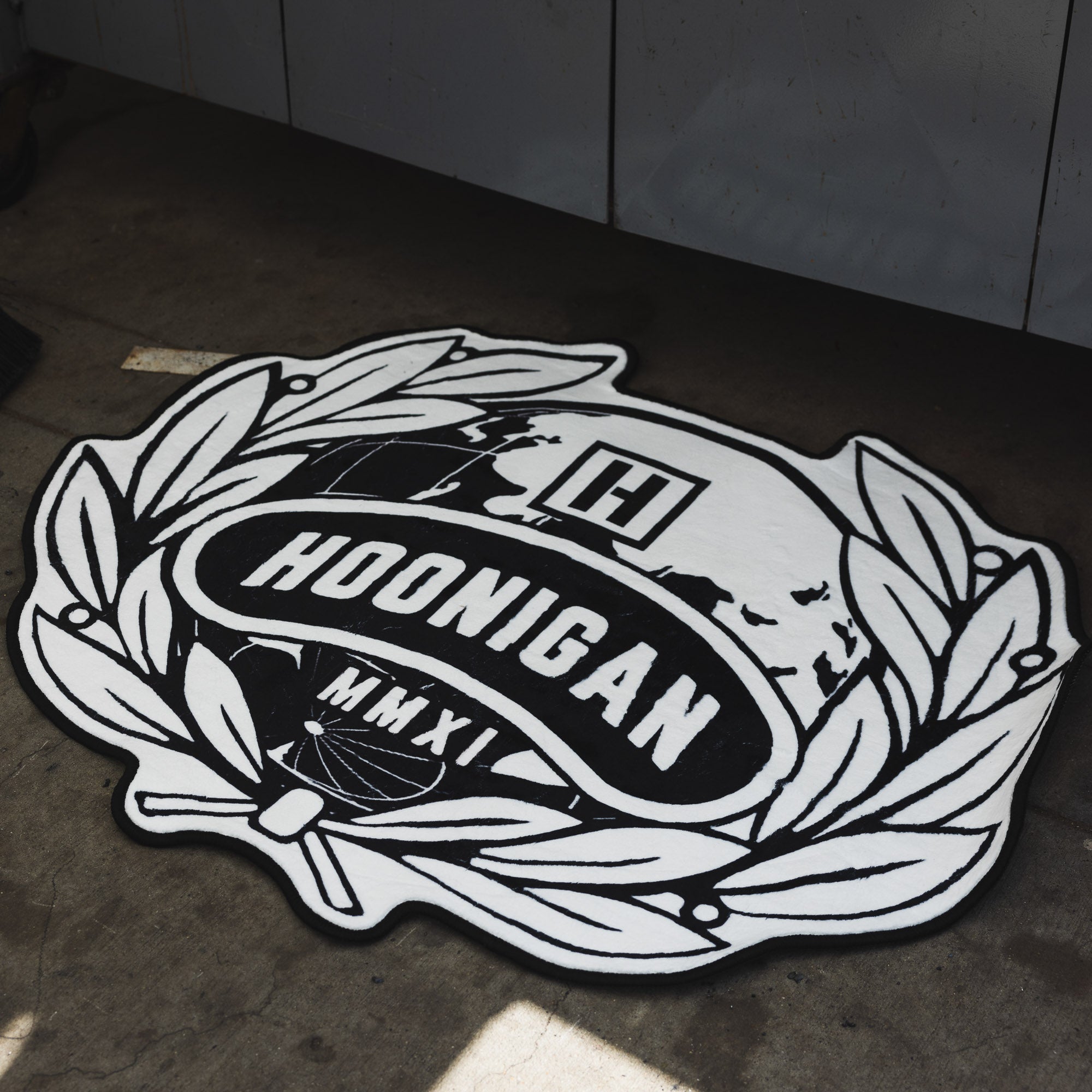 Hoonigan WORLDWIDE rug measuring 3.75 feet, featuring bold branding and a textured design.