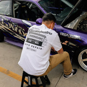 Hoonigan KNUCKLEBUSTERS AUTO REPAIR Short Sleeve Tee in black, featuring a white graphic logo on the front.