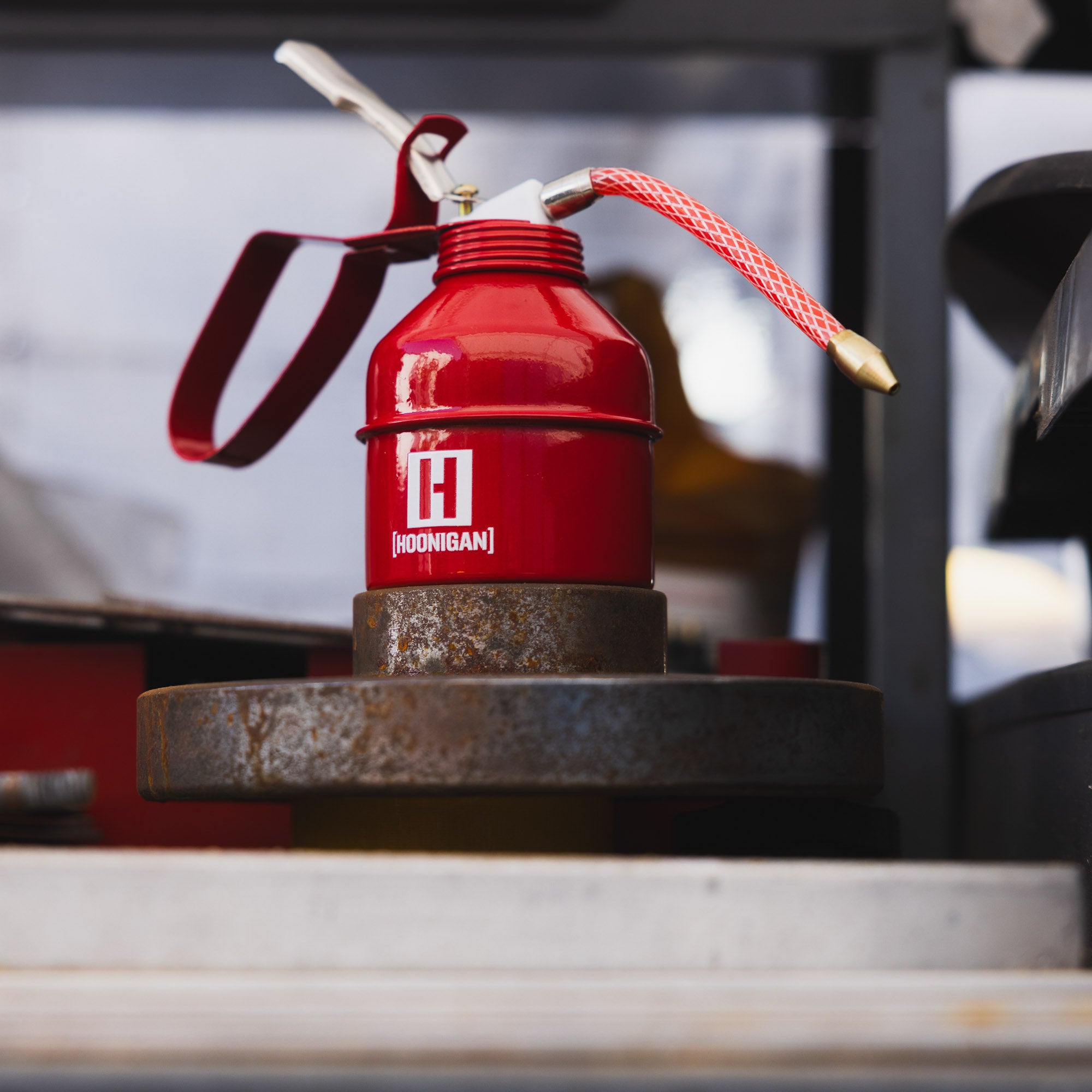 Hoonigan oil can with a black and white design featuring the Hoonigan logo and a durable handle.