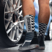 Hoonigan NEVER LIFT socks featuring a black and white design with a logo print.