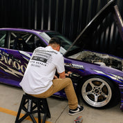 Hoonigan KNUCKLEBUSTERS AUTO REPAIR black short sleeve t-shirt featuring a graphic design of a wrench and automotive elements.