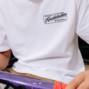 Black short sleeve tee featuring "Hoonigan KNUCKLEBUSTERS AUTO REPAIR" graphic on the front.