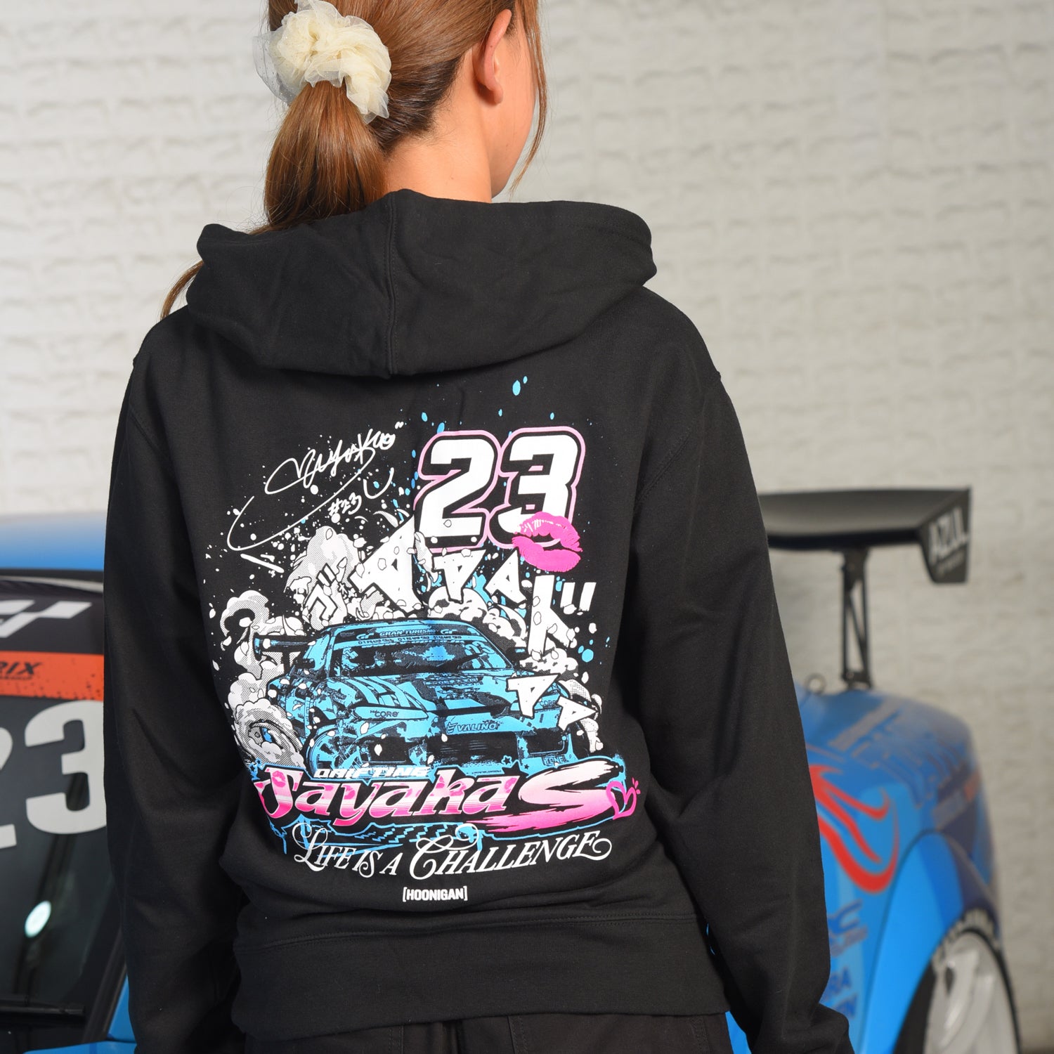 Hoonigan x Sayaka drifting hoodie featuring a bold graphic design and vibrant colors, perfect for motorsport enthusiasts.