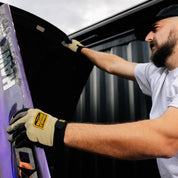 Hoonigan KNUCKLEBUSTERS gloves featuring a black and white design with reinforced knuckles and grip-enhancing palm, ideal for motorsport enthusiasts.