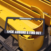 Hoonigan license plate frame with bold white text reading "[HOONIGAN]" and "FCK AROUND & FIND OUT" on a black background.
