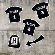 Hoonigan grab bag featuring three black shirts labeled 1, 2, and 3, alongside a drawstring bag with the Hoonigan logo.