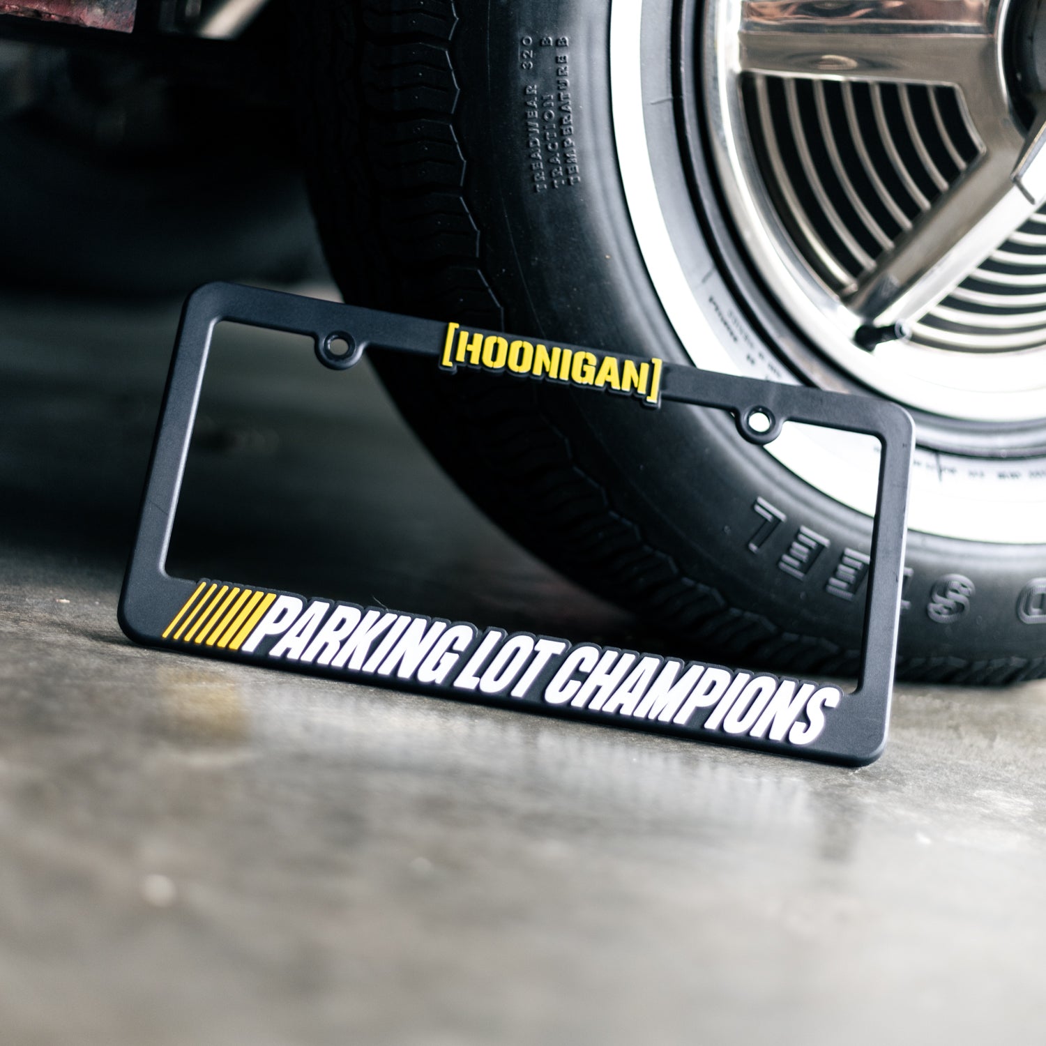 Hoonigan PARKING LOT CHAMPIONS license plate frame featuring a bold design and durable construction.
