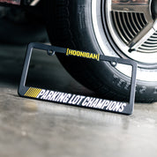 Hoonigan PARKING LOT CHAMPIONS license plate frame featuring a bold design and durable construction.