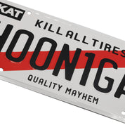 Hoonigan KARI license plate featuring a sleek black design with bold white lettering and logo, mounted on a textured background.