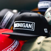 Hoonigan CENSOR BAR Snapback Hat featuring bold logo on a black cap, surrounded by various colored hats.