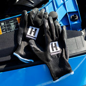 Hoonigan HBOX work gloves featuring a rugged design with reinforced palms, adjustable wrist straps, and a breathable material for enhanced grip and comfort.