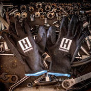 Hoonigan HBOX work gloves featuring a durable design, reinforced palms, and a black and neon green color scheme.