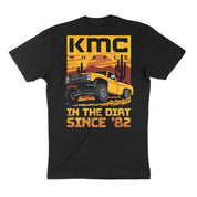 Black short sleeve t-shirt featuring a vintage truck graphic with "KMC WHEELS IN THE DIRT SINCE '82" text.