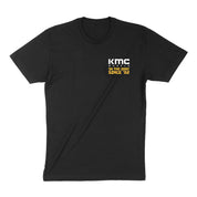 Black short sleeve t-shirt featuring KMC logo and "IN THE DIRT SINCE '82" text, perfect for motorsport enthusiasts.