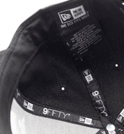 KMC BLANKET Snapback Hat in black with a flat brim and adjustable strap, featuring a textured blanket pattern.