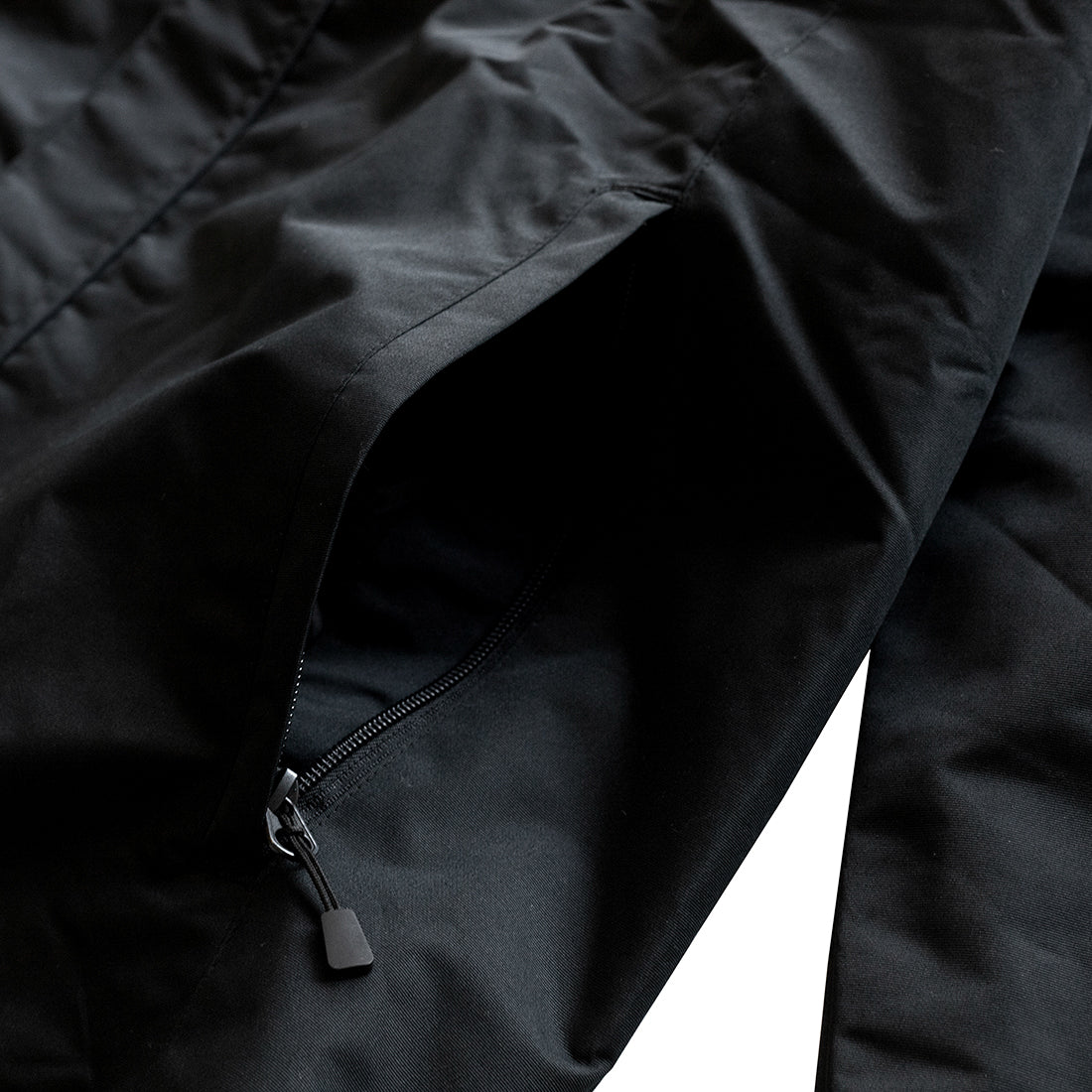 KMC Jacket in black, featuring a stylish design with zip closure and multiple pockets.
