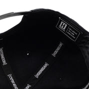 KMC Logo Snapback Hat featuring a bold embroidered logo on the front and an adjustable snap closure.