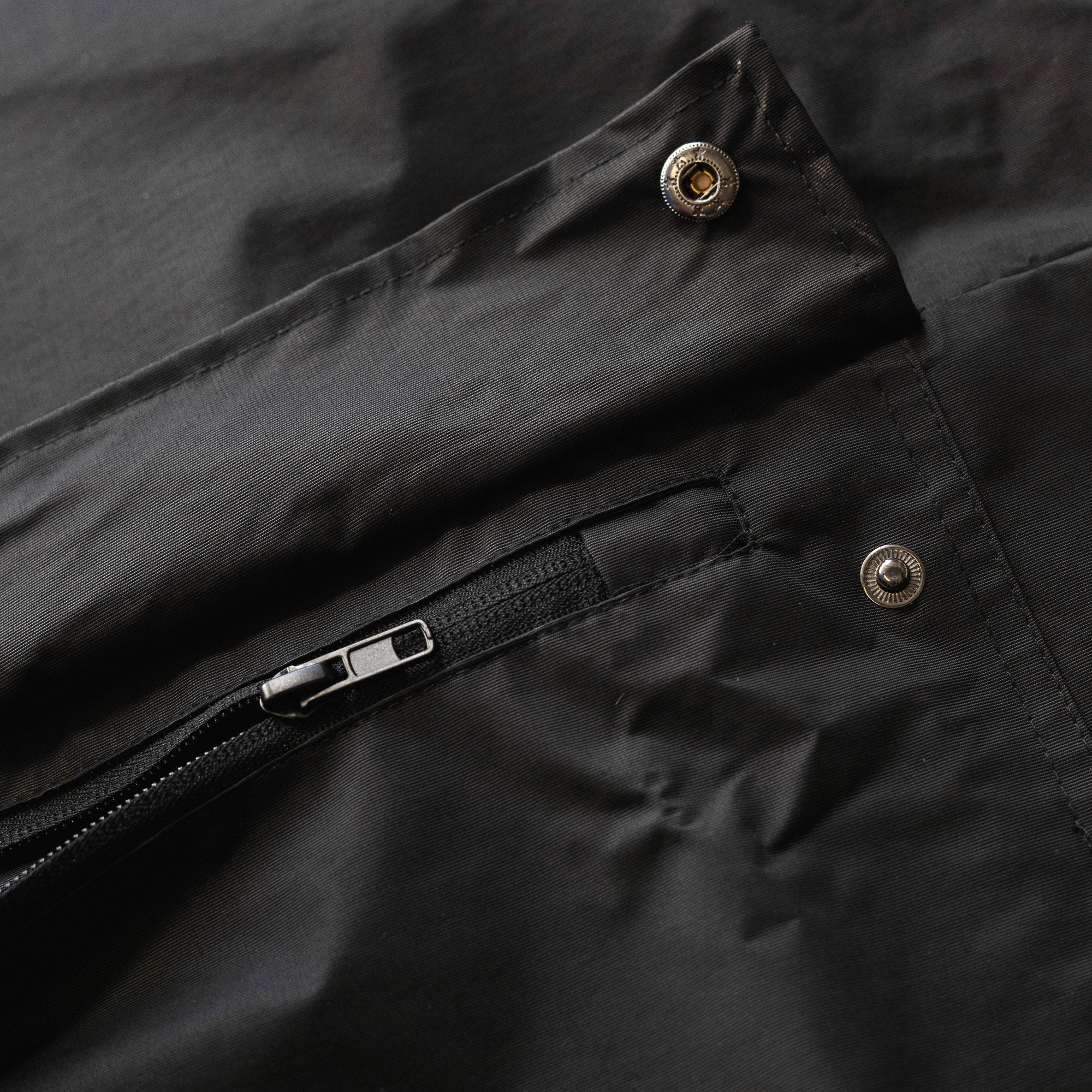 KMC Wheels V2 Half Zip Anorak Jacket in black with a large logo on the chest, featuring a half zipper and adjustable hood.