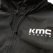 KMC Wheels V2 Half Zip Anorak Jacket in black, featuring a pullover design, half zip closure, and adjustable hood.
