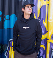 Black and white Rotiform STAPLE hoodie featuring a front logo design, modeled casually in a lifestyle setting.