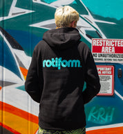 Black and teal Rotiform STAPLE hoodie with logo, shown from the back in a lifestyle setting.