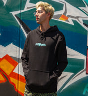Rotiform STAPLE hoodie in black and teal, featuring the Rotiform logo on the front, worn casually in a lifestyle setting.