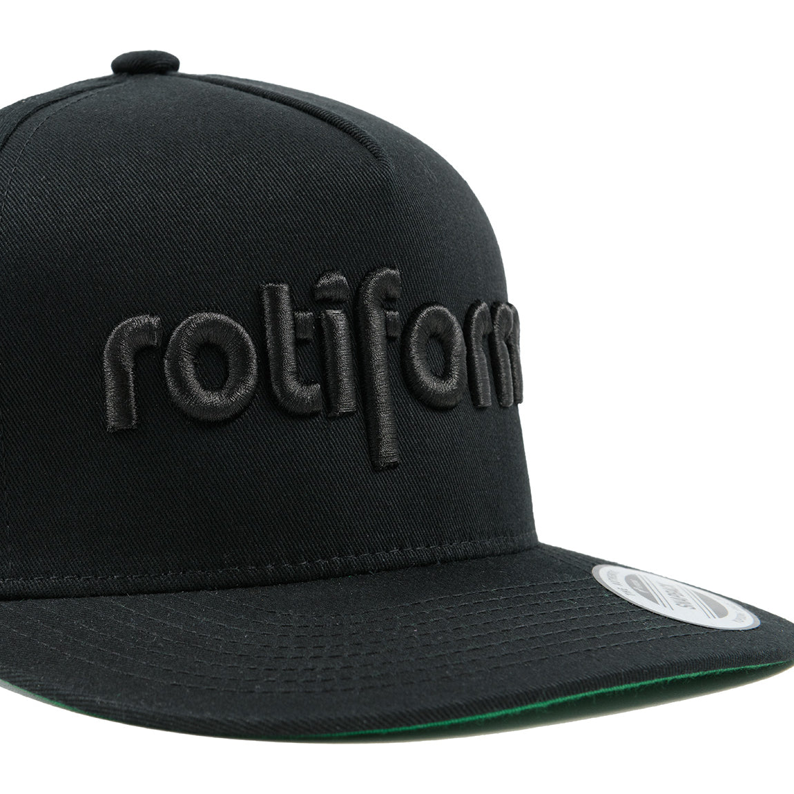 Rotiform STAPLE Snapback Hat in black with embroidered logo detail on the front.