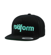 Rotiform STAPLE Snapback Hat in black with a bold white logo on the front, featuring a flat brim and adjustable strap at the back.