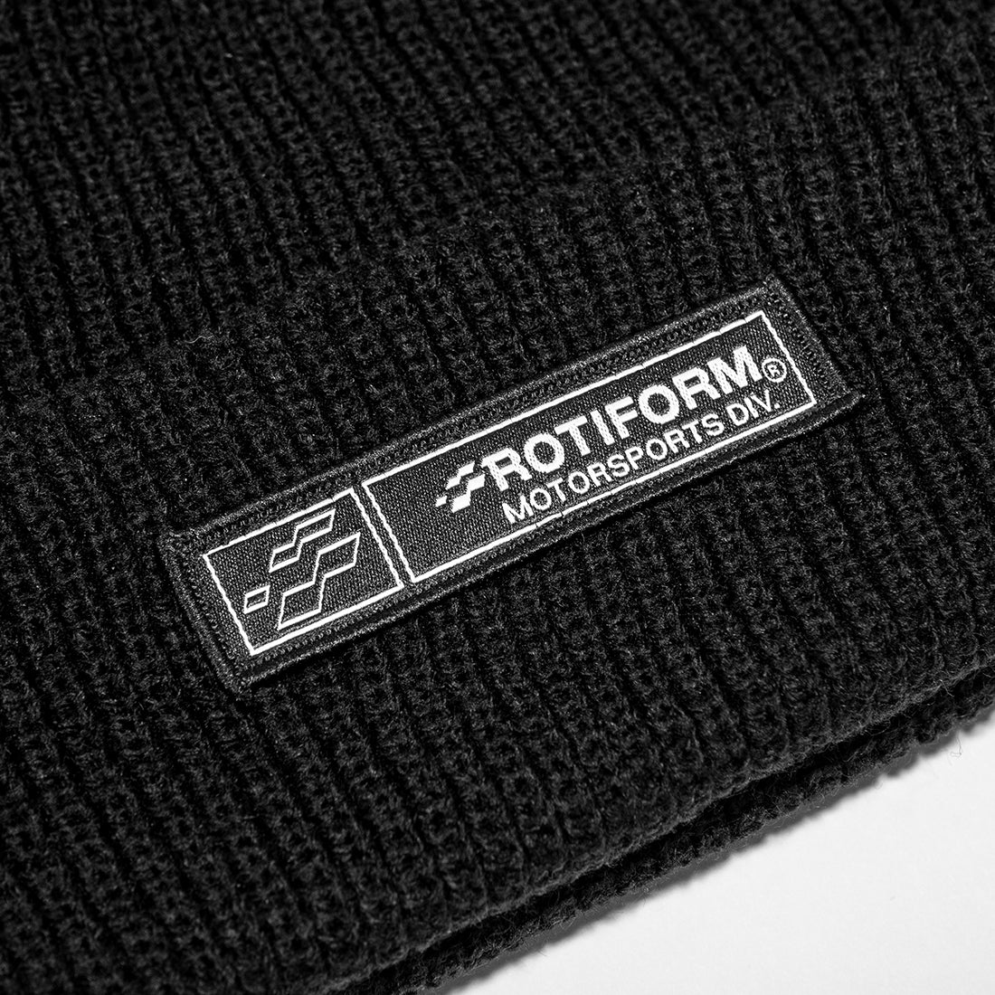 Rotiform MOTORSPORTS DIV Beanie in black with white logo, showcasing a stylish and cozy design for automotive enthusiasts.