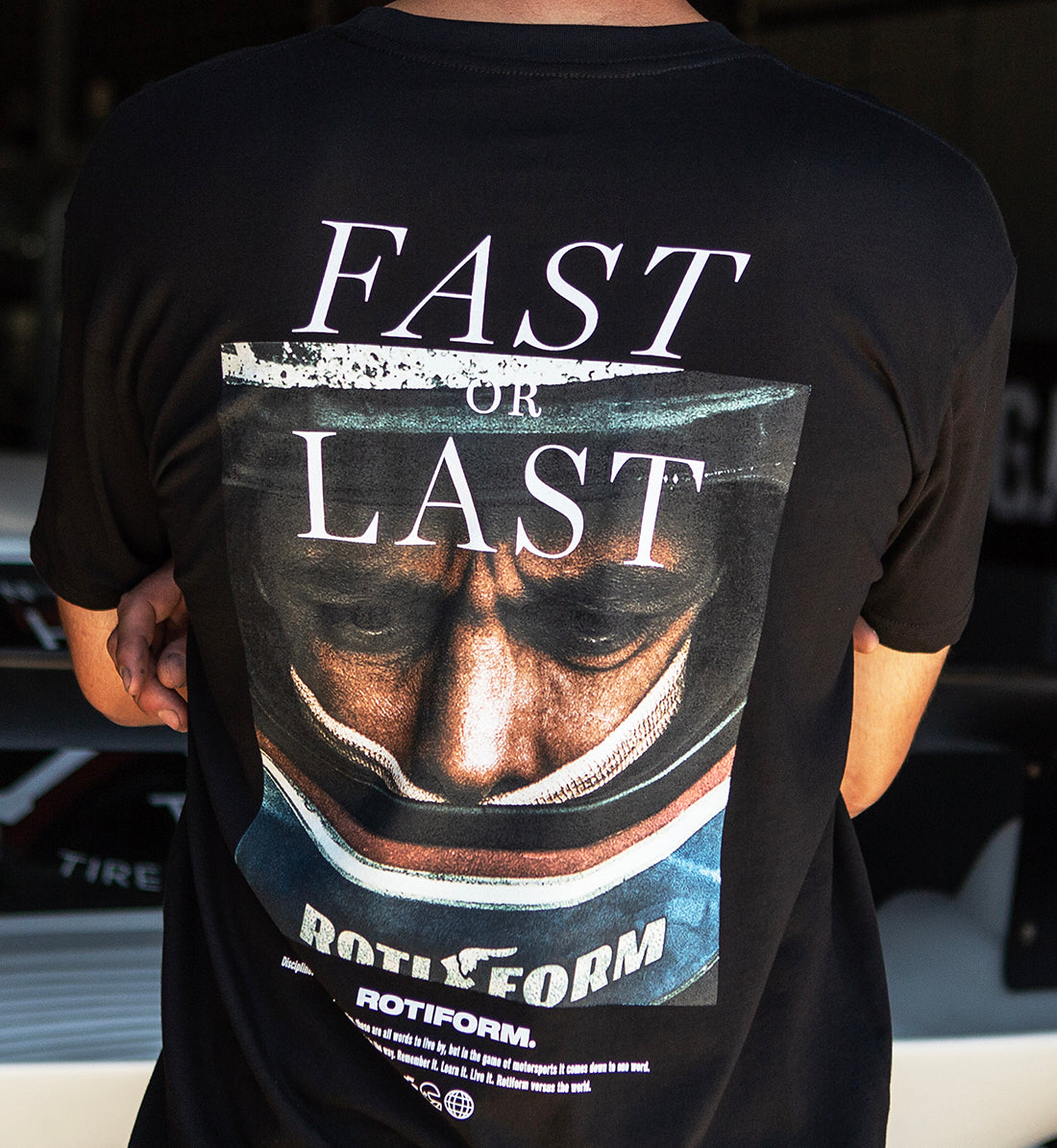 Back view of the Rotiform FAST OR LAST Short Sleeve Tee in black, featuring a bold graphic design.