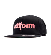 Rotiform STAPLE Snapback Hat featuring a black design with a front angled view showcasing the prominent Rotiform logo.