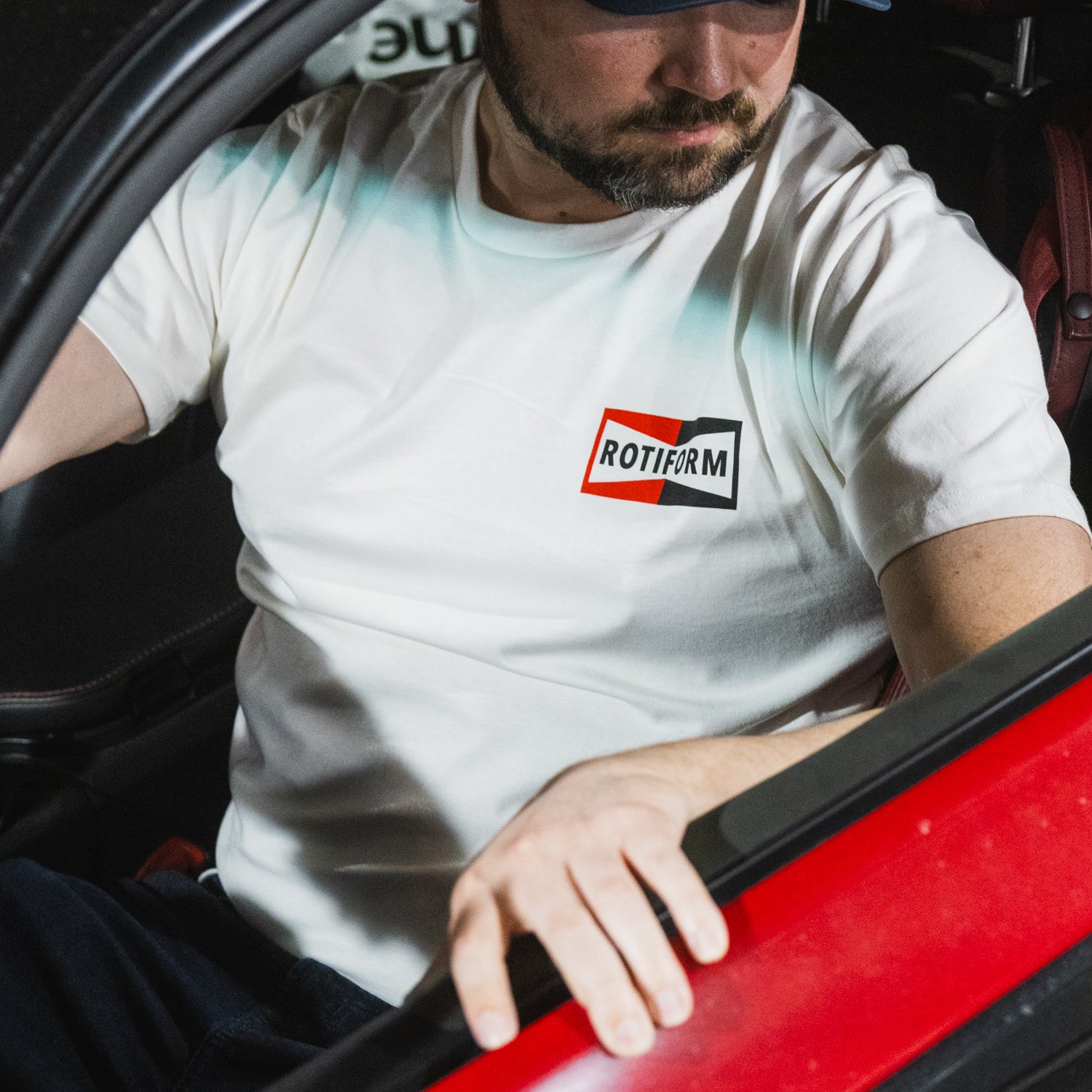 Rotiform NEED THAT PLUG Short Sleeve Tee in black featuring a bold graphic logo on the front.