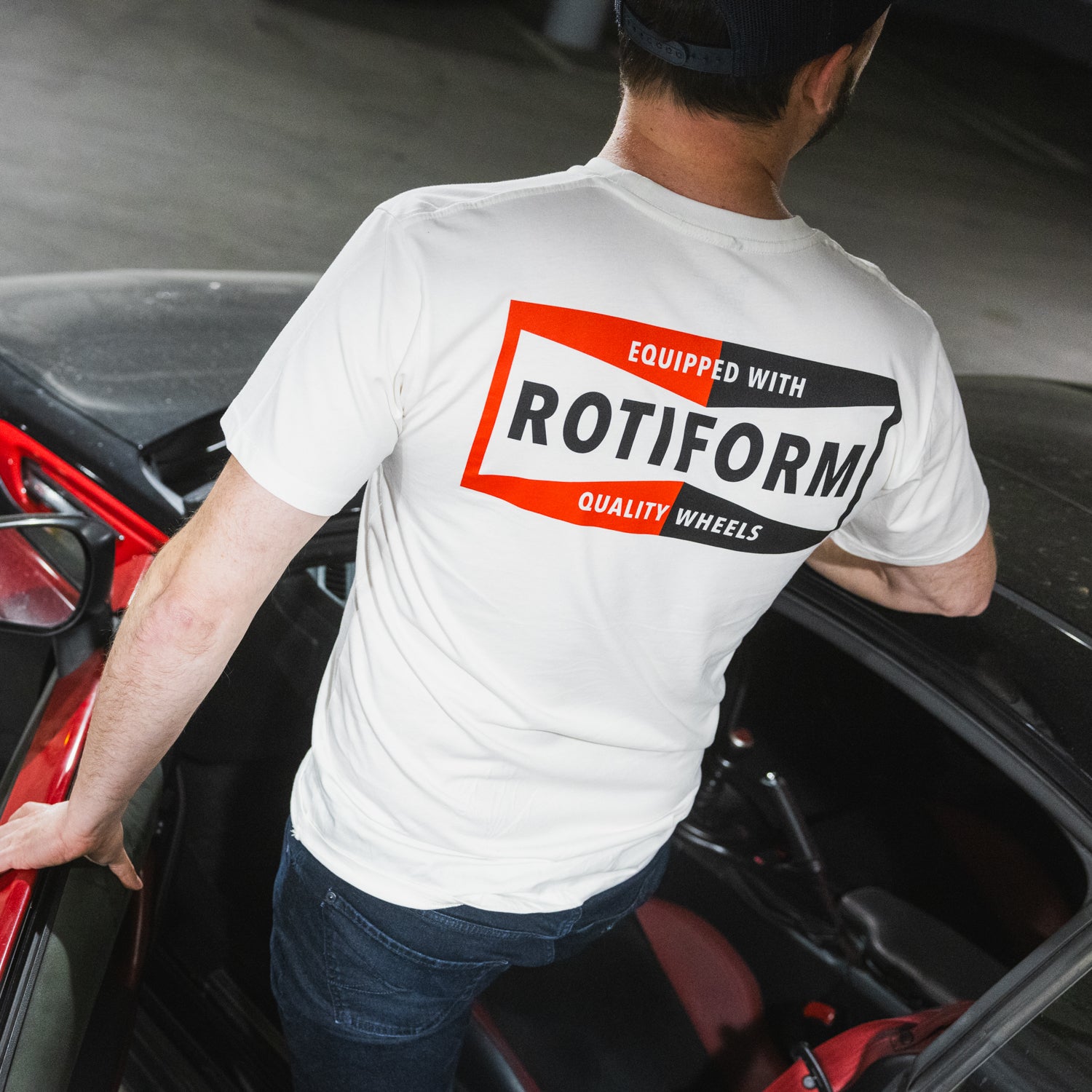 Rotiform NEED THAT PLUG Short Sleeve Tee in black, featuring a bold graphic logo on the front.