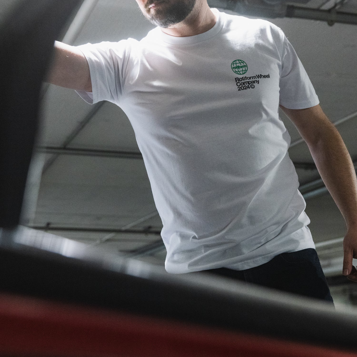 Rotiform NEED WHEELS Short Sleeve Tee featuring a graphic design, black fabric, and a modern fit.