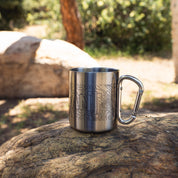 Stainless steel mug with topographic map design and a carabiner handle, ideal for outdoor adventures and camping.