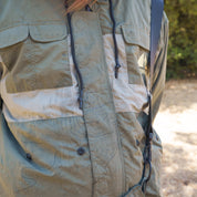 Close-up of a Hoonigan H.A.V.O.C. rain-activated windbreaker jacket with multiple pockets, drawstrings, and weather-resistant fabric.